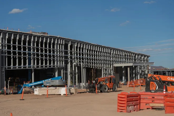 A data center building is seen in the background as members of the media tour Project Jupiter in Santa Teresa, N.M., on Tuesday, Oct. 13, 2026.