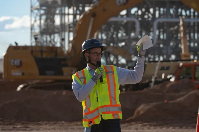 osh Timberlake, senior vice president of site strategy at STACK Infrastructure, speaks to members of the media in front of a cooling facility under construction during a tour of Project Jupiter in Santa Teresa, N.M., on Tuesday, Oct. 13, 2026.