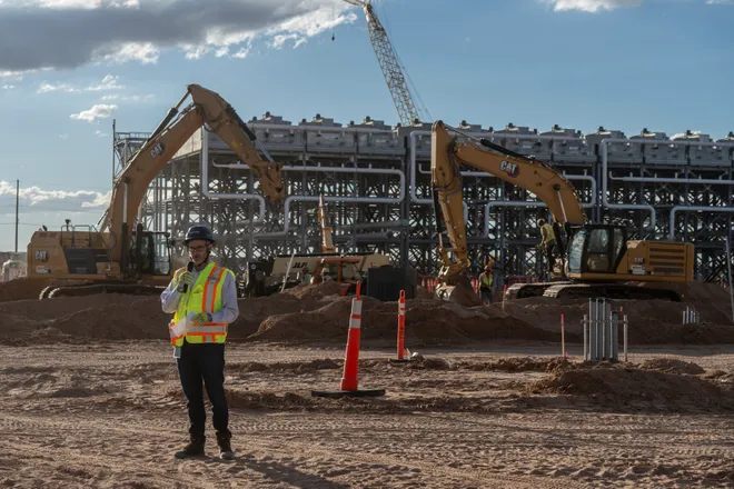 osh Timberlake, senior vice president of site strategy at STACK Infrastructure, speaks to members of the media in front of a cooling facility under construction during a tour of Project Jupiter in Santa Teresa, N.M., on Tuesday, Oct. 13, 2026.