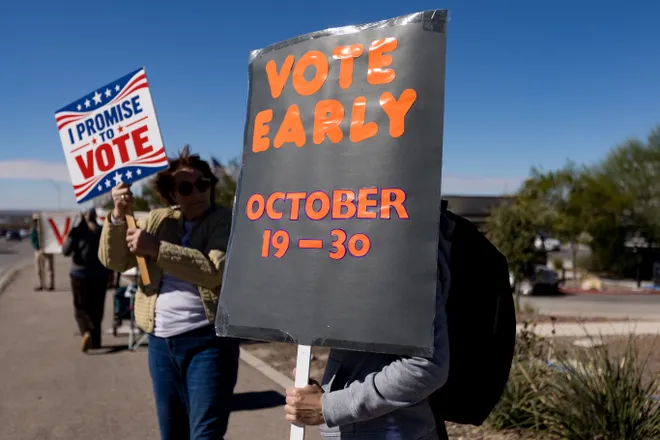 Participants hold signs encouraging early voting along Eastlake Boulevard during a “No Kings” sidewalk protest organized by Indivisible the 915 in El Paso, Texas, on Saturday, Oct. 17, 2026.