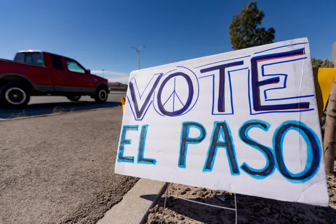 A truck passes a sign reading “Vote El Paso” along Eastlake Boulevard during a “No Kings” sidewalk protest organized by Indivisible the 915 in El Paso, Texas, on Saturday, Oct. 17, 2026.