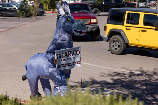 A participant wearing an inflatable donkey costume holds a “Talarico for Texas” sign during a “No Kings” sidewalk protest organized by Indivisible the 915 along Eastlake Boulevard in El Paso, Texas, on Saturday, Oct. 17, 2026.