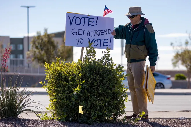 A participant holds a sign encouraging people to vote along Eastlake Boulevard during a “No Kings” sidewalk protest organized by Indivisible the 915 in El Paso, Texas, on Saturday, Oct. 17, 2026.