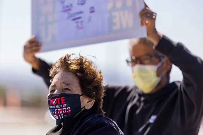 A participant wears a mask reading “Vote because your life depends on it” during a “No Kings” sidewalk protest organized by Indivisible the 915 along Eastlake Boulevard in El Paso, Texas, on Saturday, Oct. 17, 2026.