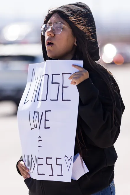 A participant holds a sign reading “Choose love and kindness” along Eastlake Boulevard during a “No Kings” sidewalk protest organized by Indivisible the 915 in El Paso, Texas, on Saturday, Oct. 17, 2026.