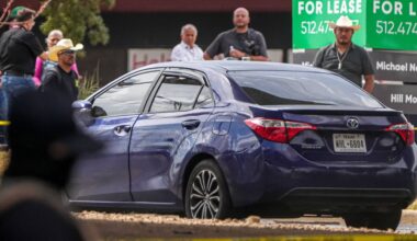 A vehicle is left in the street after a man was shot in his vehicle by an ICE officer, Sunday, Sept. 20, 2026, in Austin, Texas. (Aaron E. Martinez /Austin American-Statesman via AP)