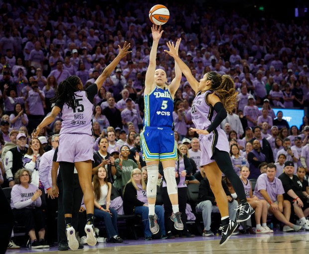 Dallas Wings' Paige Bueckers (5) takes a shot against Golden State Valkyries' Tiffany Hayes (15) and Golden State Valkyries' Veronica Burton (22) in the fourth quarter at the Chase Center in San Francisco, Calif., on Thursday, Oct. 2, 2026. (Shae Hammond/Bay Area News Group)