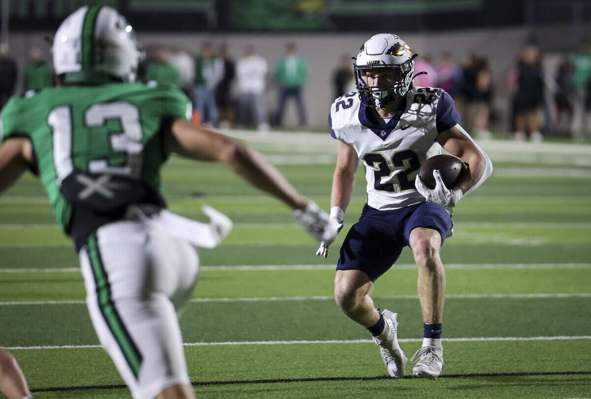 Keller running back Blake Dyniewski (22) runs the ball during the first half of the game against Southlake Carroll on Friday, Oct. 16, 2026, at Dragon Stadium in Southlake.