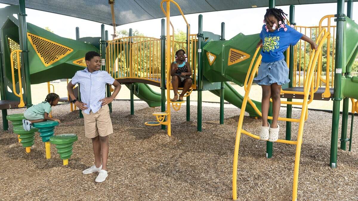 Siblings Gabriel, 4, left, Deshawn, 13, second from left, Moriah, 10, second from right, and Aniyah Lomax, 8, right, play together on the playground next to Briscoe Elementary School in Fort Worth on Saturday, July 12, 2025.