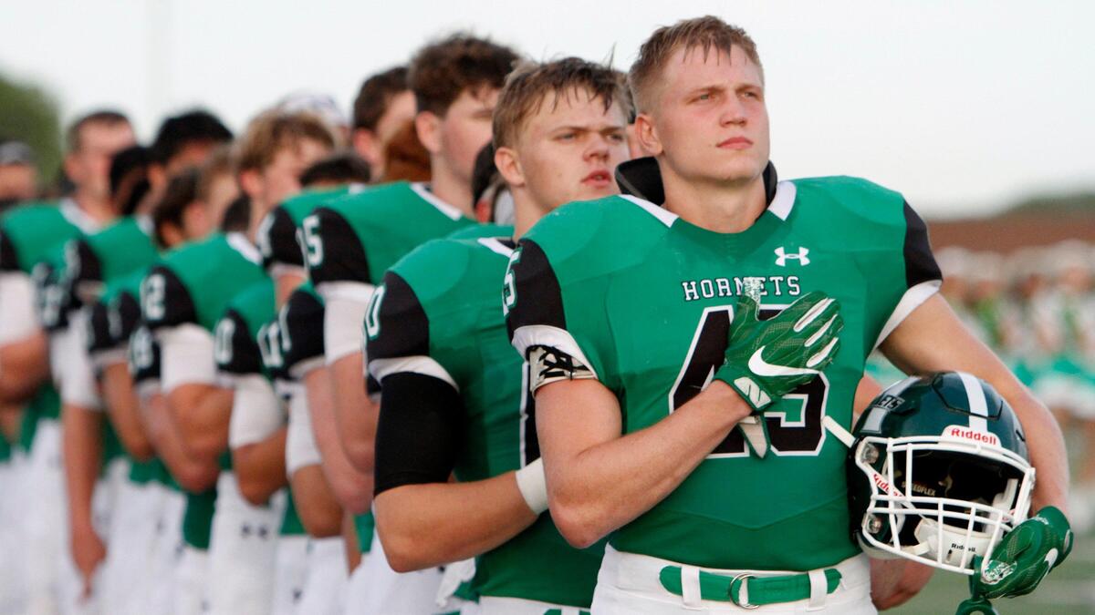 The Azle Hornets line up for the anthem before a game against Grapevine on Aug. 30, 2019, in Azle.