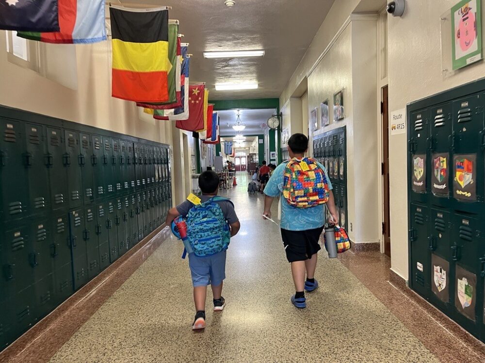Two students walking down the hallway of Houston ISD's River Oaks Elementary.