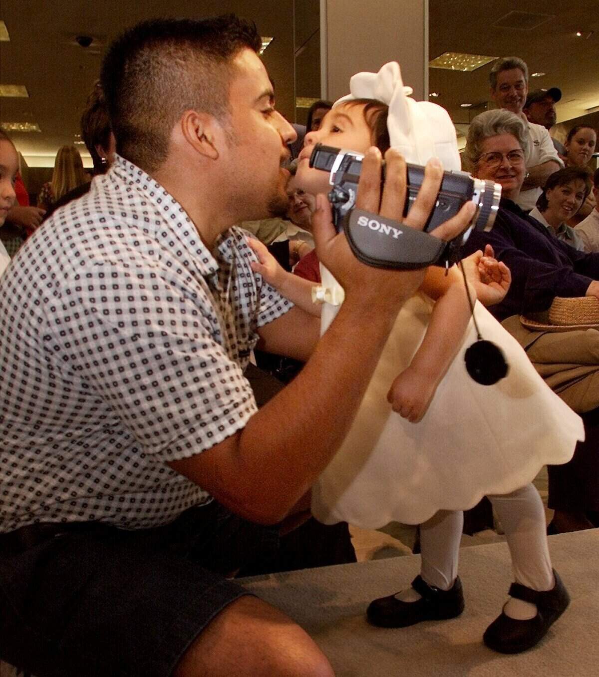 In August 2001, nineteen-month-old Reyna Ramirez kissed her dad Steve as she participated in a children’s fashion show at the Ridgmar Mall in August 2001.