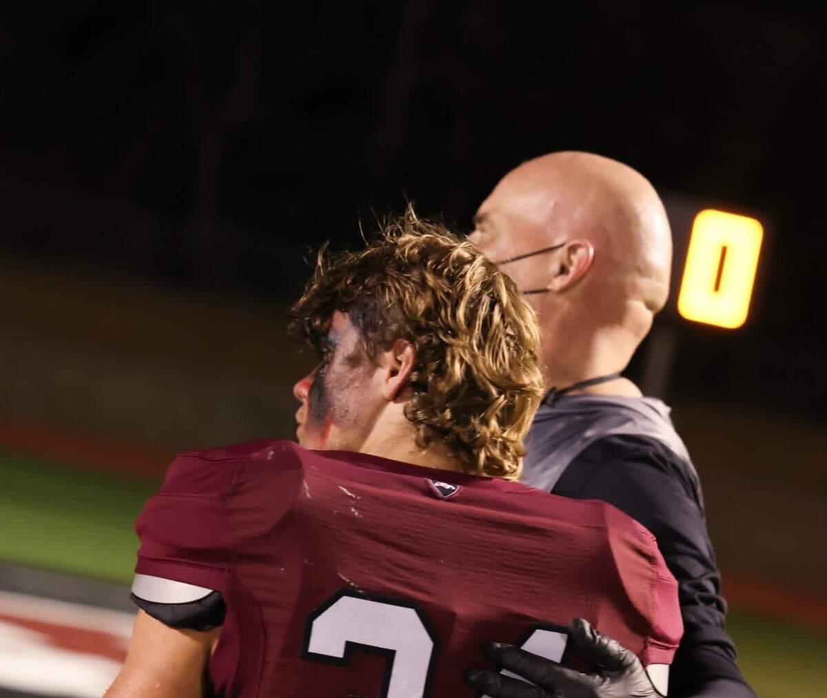 Millsap head coach Jacob Johnson is photographed with his son, Braun Johnson, at a football game.
