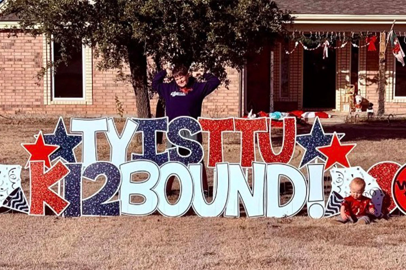 Yard card in Texas Tech colors that reads "Ty is TTU K-12 Bound!"