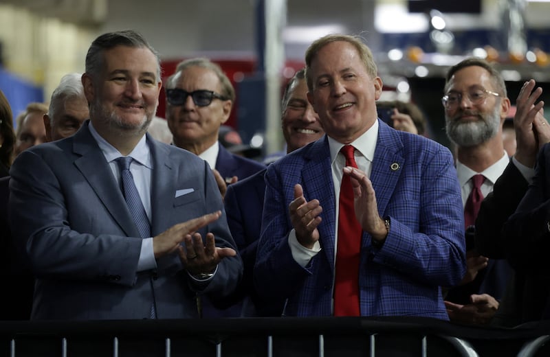 Texas Attorney General Ken Paxton, candidate for US Senate, and US Senator Ted Cruz (R-TX) applaud together during US President Donald Trump's visit to Peterbilt Motors in Denton, Texas, US, October 1, 2026.