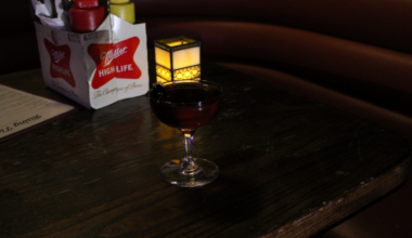 A Malorthattan served with two cherries in a classic martini glass at Rising Tides Bar.