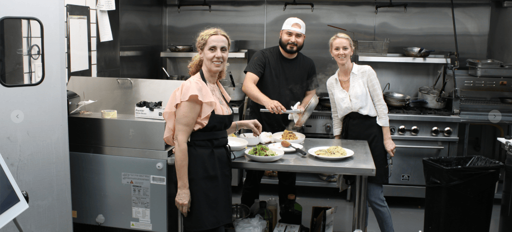 Vjosa and Gondze pose for a picture in Sorella's open kitchen.
