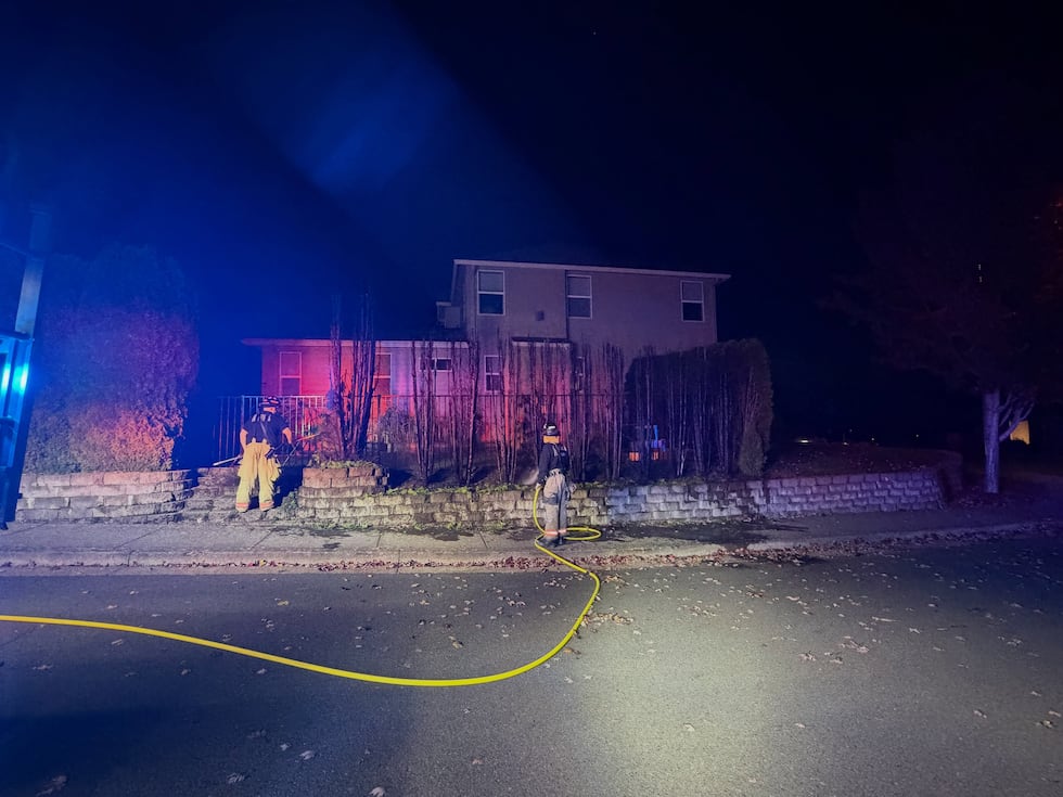 A row of burned arborvitae trees after a fire near a home in Dallas, Ore. on the morning of...