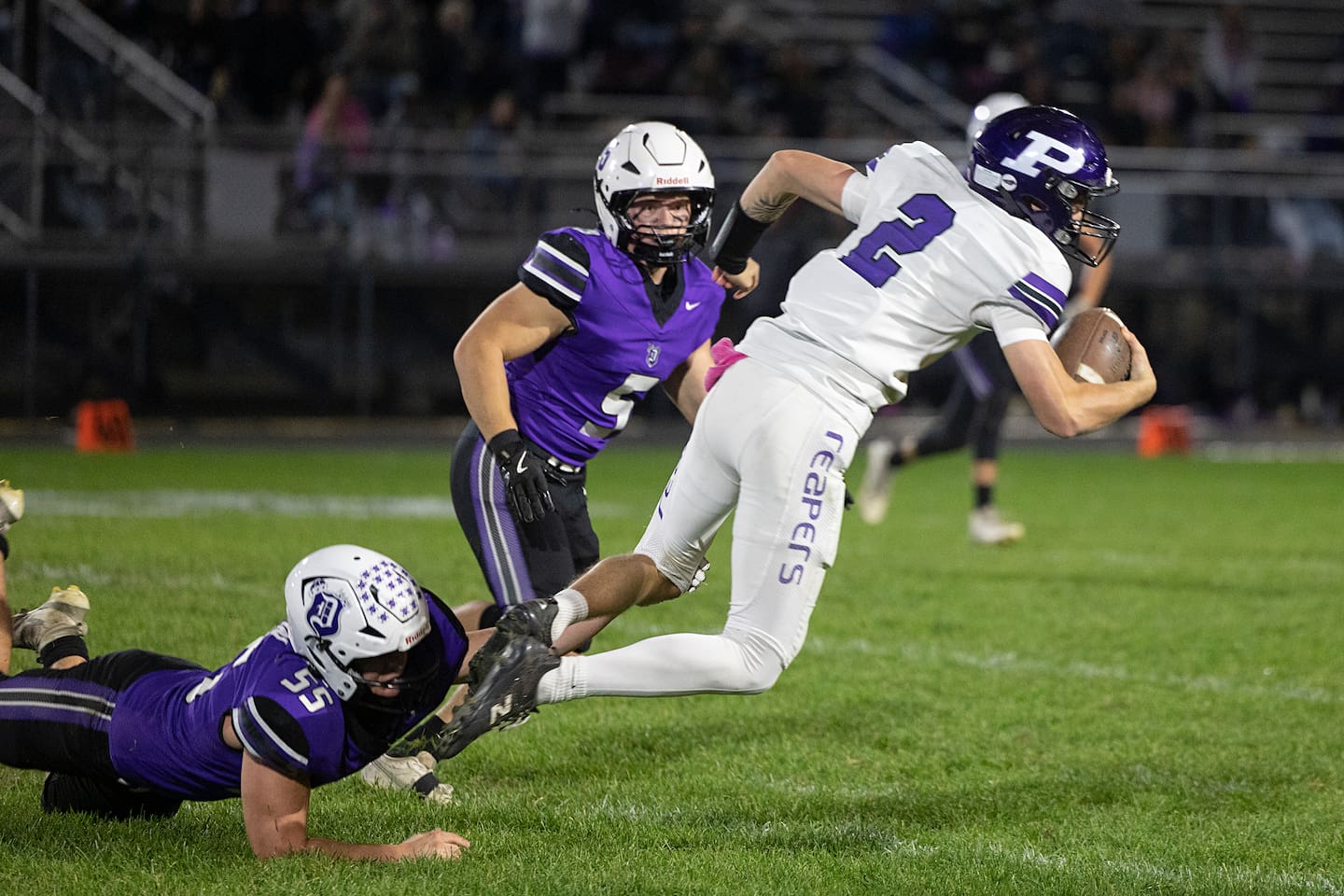 Plano’s Braylon Schmidt is tripped up by Dixon’s Blaine Eberhardt Friday, Oct. 23, 2026.