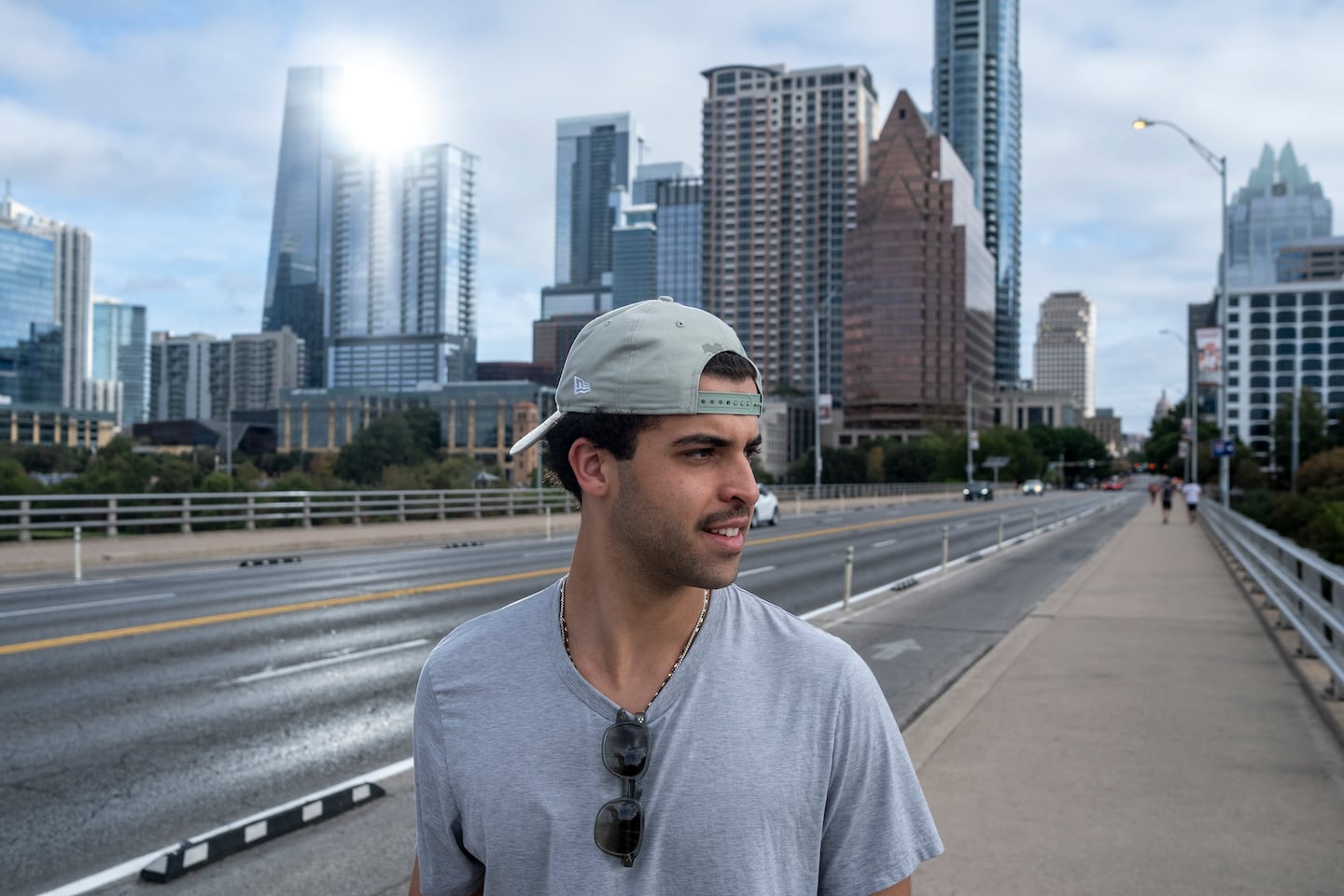 Bisono walked along the Congress Avenue Bridge, with the city's skyline as a backdrop.