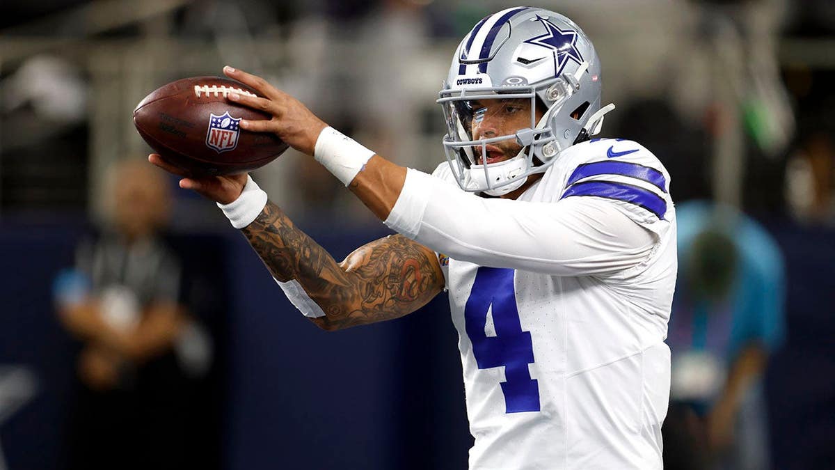 Dak Prescott warms up before a game at AT&T Stadium.