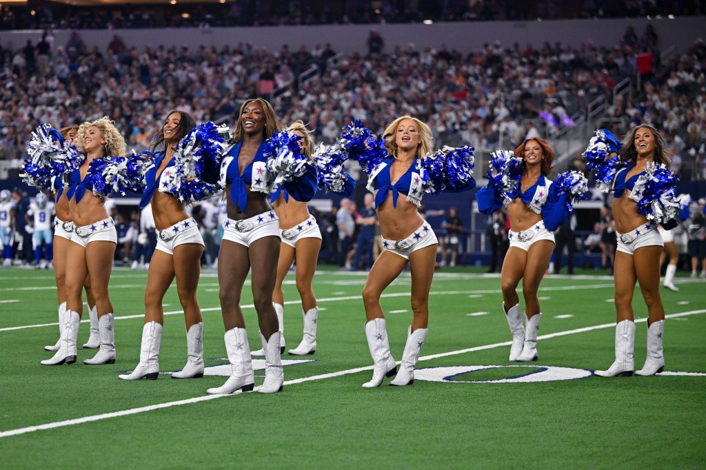 The Dallas Cowboys cheerleaders perform on the field during a game against the Buccaneers at AT&T Stadium.