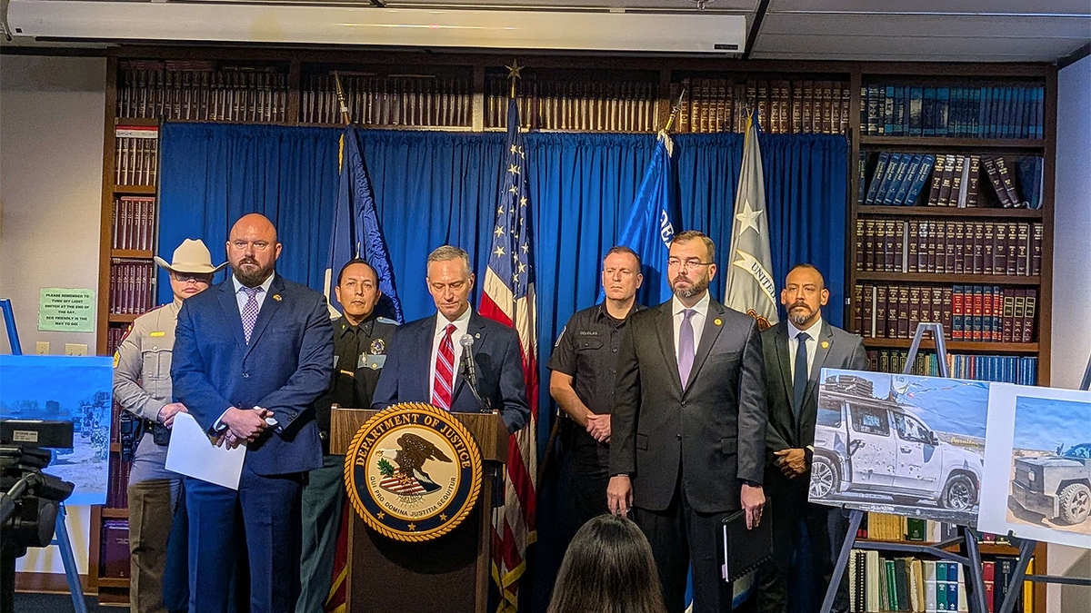 Law enforcement officials stand behind a podium during a press conference in El Paso, Texas