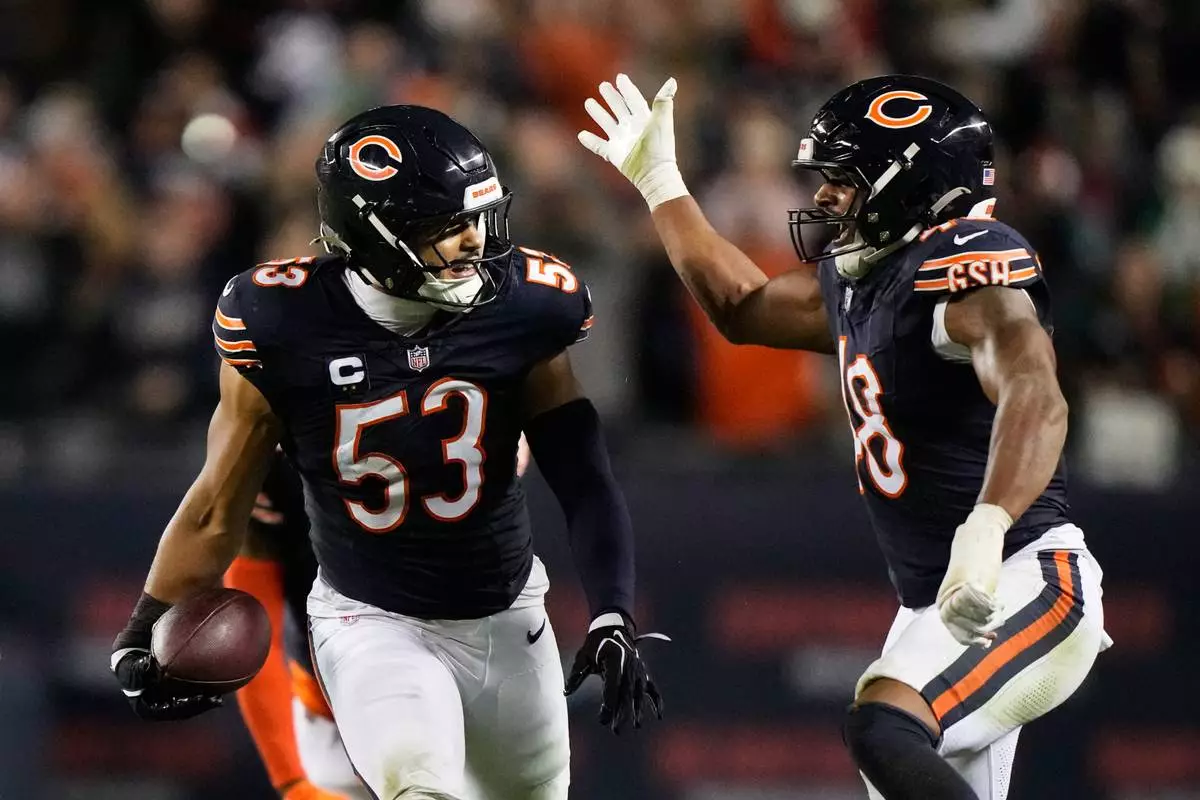 Chicago Bears linebacker T.J. Edwards (53) and linebacker D'Marco Jackson, right, celebrate after Edwards intercepted a pass during the second half of an NFL football game against the Philadelphia Eagles in Chicago, Monday, Sept. 28, 2026. (AP Photo/Nam Y. Huh)