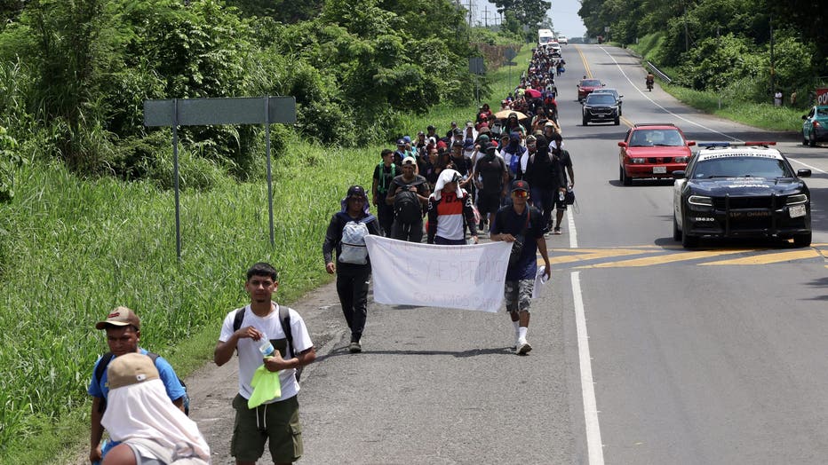 Migrants advance in a caravan after crossing into Mexico while traveling toward the United States in Ciudad Hidalgo, Mexico, on September 24, 2026.