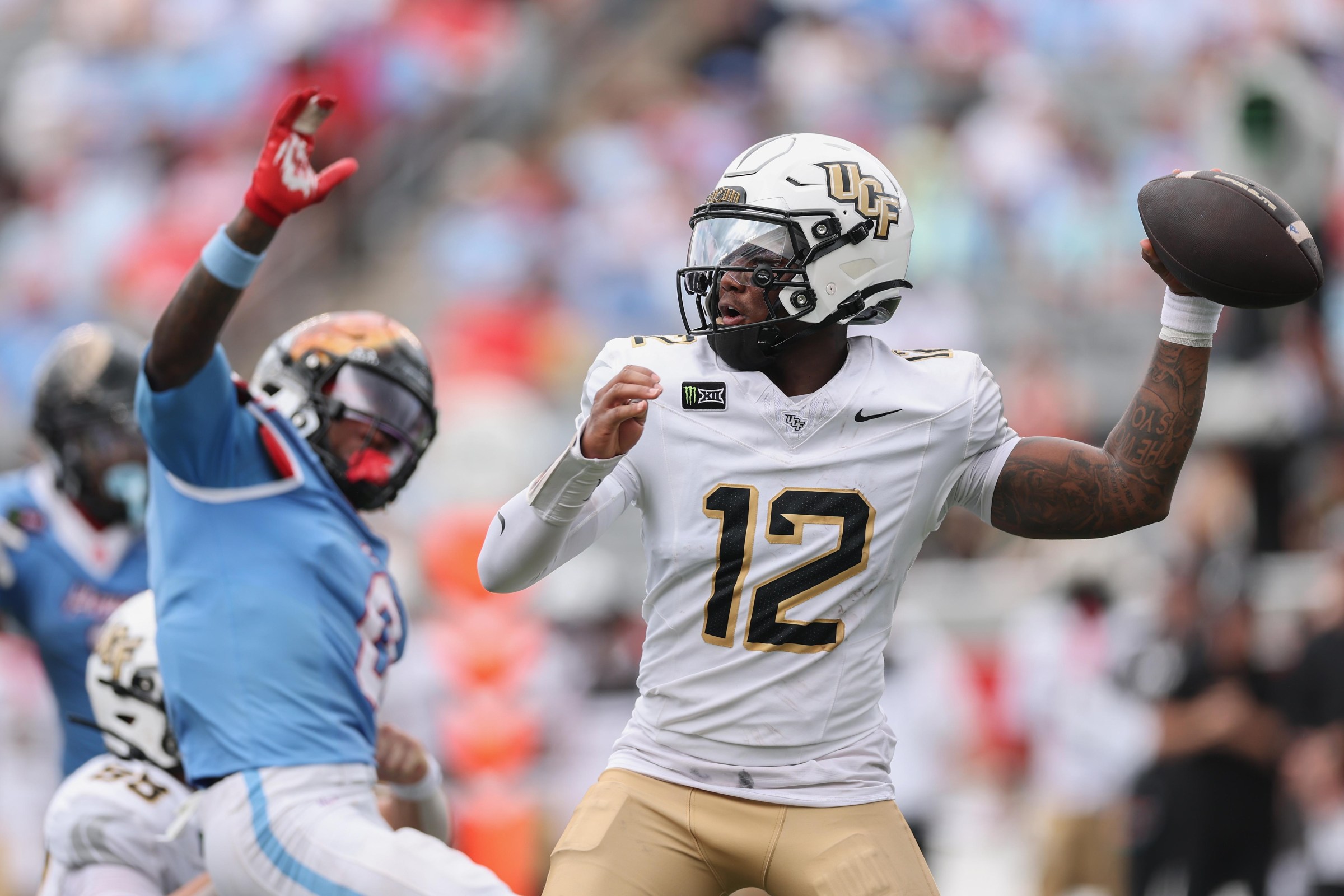 HOUSTON, TEXAS - OCTOBER 03: Keyone Jenkins #12 of the UCF Knights throws a pass in the second half against the Houston Cougars at TDECU Stadium on October 03, 2026 in Houston, Texas. (Photo by Tim Warner/Getty Images)