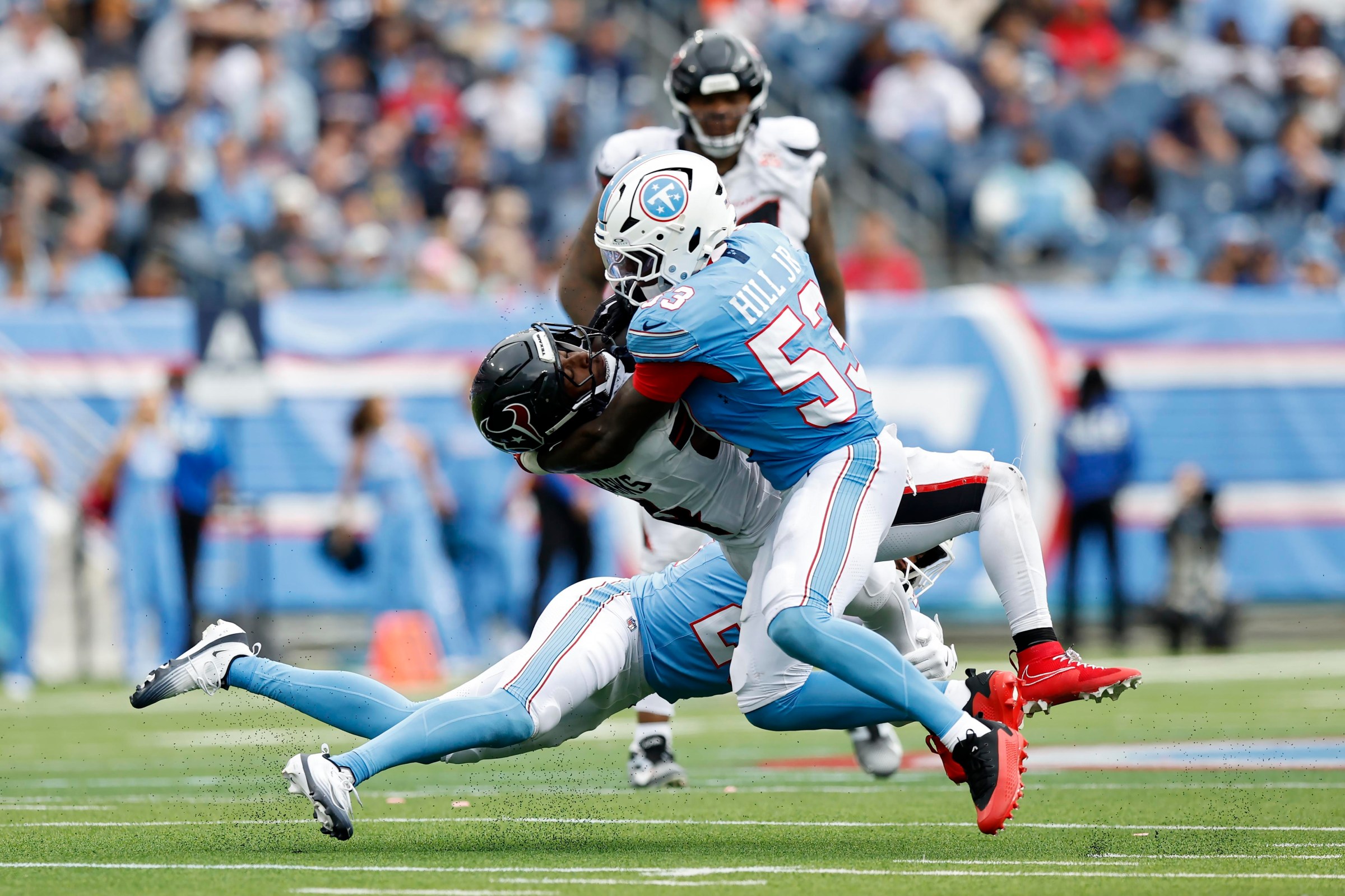 NASHVILLE, TENNESSEE - OCTOBER 11: Woody Marks #4 of the Houston Texans rushes for yards during the second half of the game against Anthony Hill Jr. #53 of the Tennessee Titans at Nissan Stadium on October 11, 2026 in Nashville, Tennessee. (Photo by Justin Ford/Getty Images)
