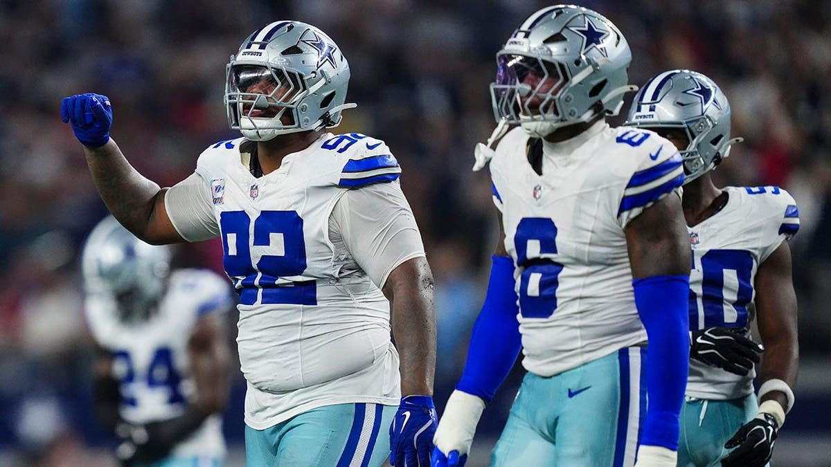 Quinnen Williams, Dallas Cowboys defensive lineman, looks on from the field during an NFL game.