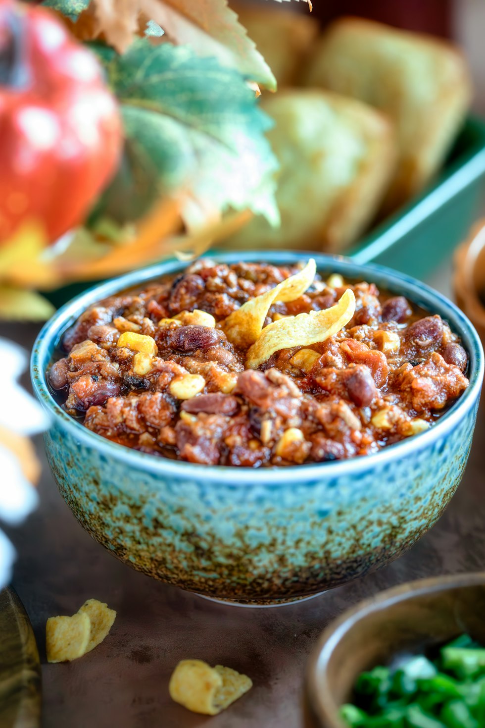 A bowl of chili next to other bowls of food