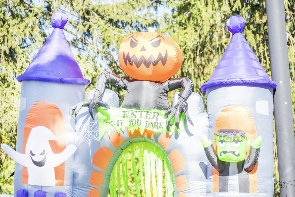 Inflatable halloween castle with pumpkin, ghosts, and frankenstein
