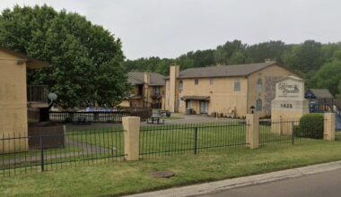 Entrance sign and buildings at River Crossing Apartments, 1023 College Drive