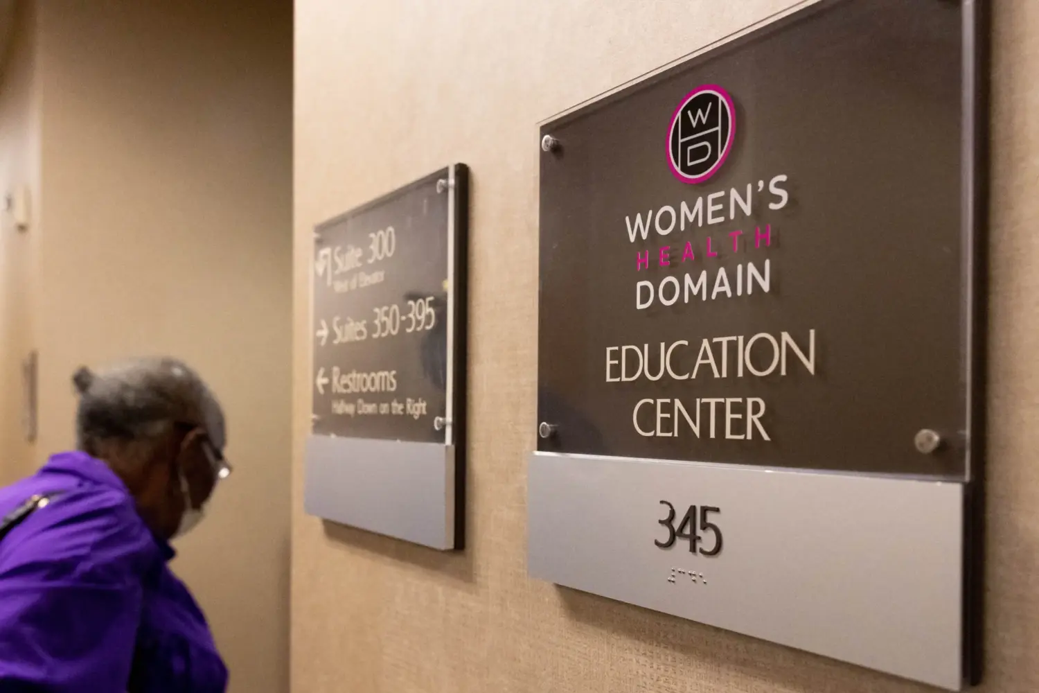 Photo of a plaque by a door in a hospital. The plaque reads "Women's Health Domain Education Center."