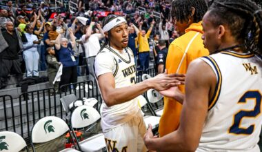 Wayne Memorial's Carlos Medlock Jr., left, shakes hands with Jalahn McClellan after beating Flint Carman-Ainsworth in the Division 1 state semifinal on Friday, March 14, 2025, at the Breslin Center in East Lansing.