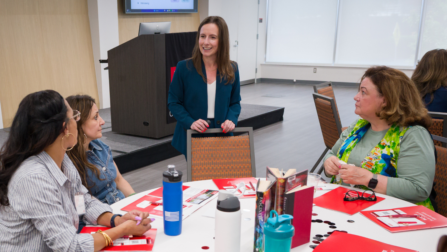 Annie Murray stands by table at the Employer Summit