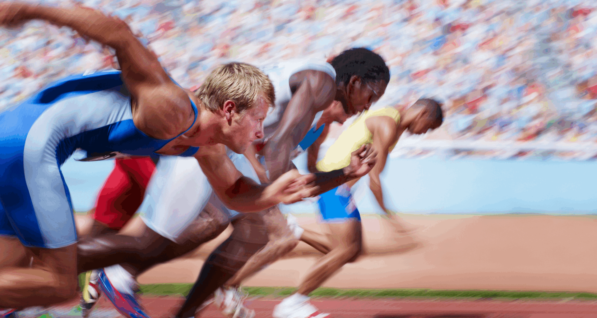 Runners jumping off the starting line for a race.