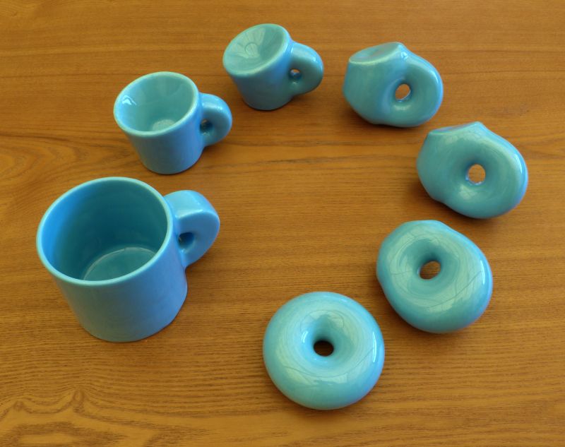 Blue ceramic models on a wooden table.