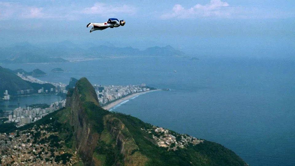 Felix Baumgartner glides through the air past the Dois Irmaos peaks in Rio de Janeiro in 2001. - Reuters