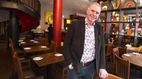 Andrew Teebay Peter Kinsella stood in a Spanish restaurant he owns in Liverpool