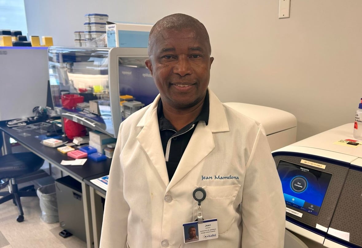 A man in a lab coat in a lab.