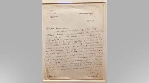 Mousumi Bakshi/BBC A framed, handwritten letter dated 1908 from Dracula author Bram Stoker to his publishers. The paper on which it is written is faded and discoloured.