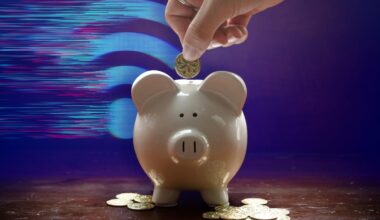 a hand depositing a coin into a piggy bank sitting on a wood table with coins scattered and a digitized wi-fi symbol in the background.