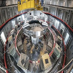 Installation of the first superconducting magnet, Poloidal Field Coil #6, in the tokamak pit at the ITER construction site. The Central Solenoid will be mounted in the center after the vacuum vessel has been assembled. Credit: ITER Organization