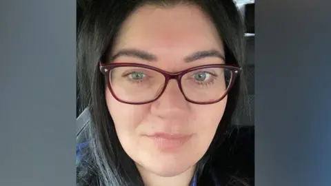 BBC Selfie of Emma McLeod who had dark hair and wears glasses.