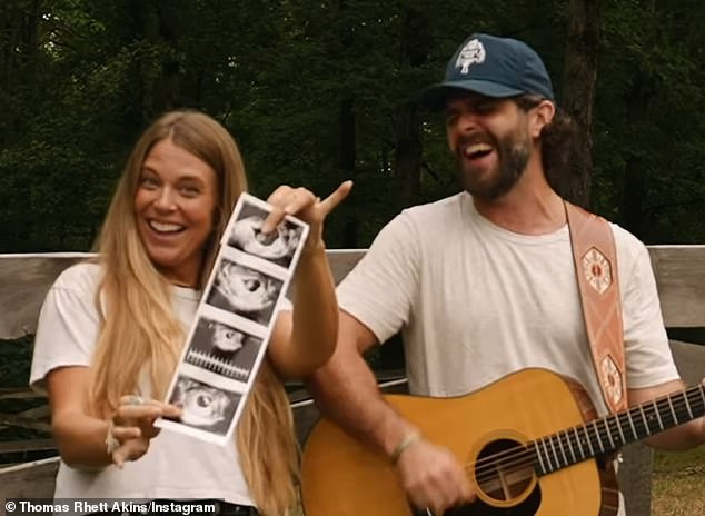 Lauren proudly held up the sonogram images of their little one, whom many in the comments hoped would be a boy