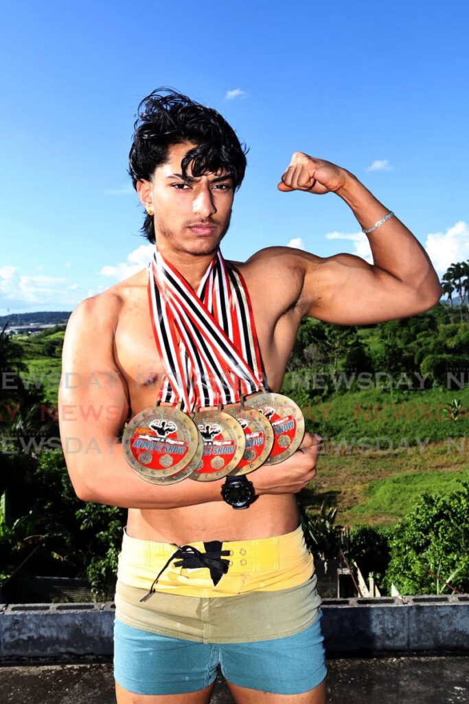 Jayden Persad shows off his medals from the National Physique Committee TT's Muscle Show in May, and Island Cup in August. - Photo by Lincoln Holder 