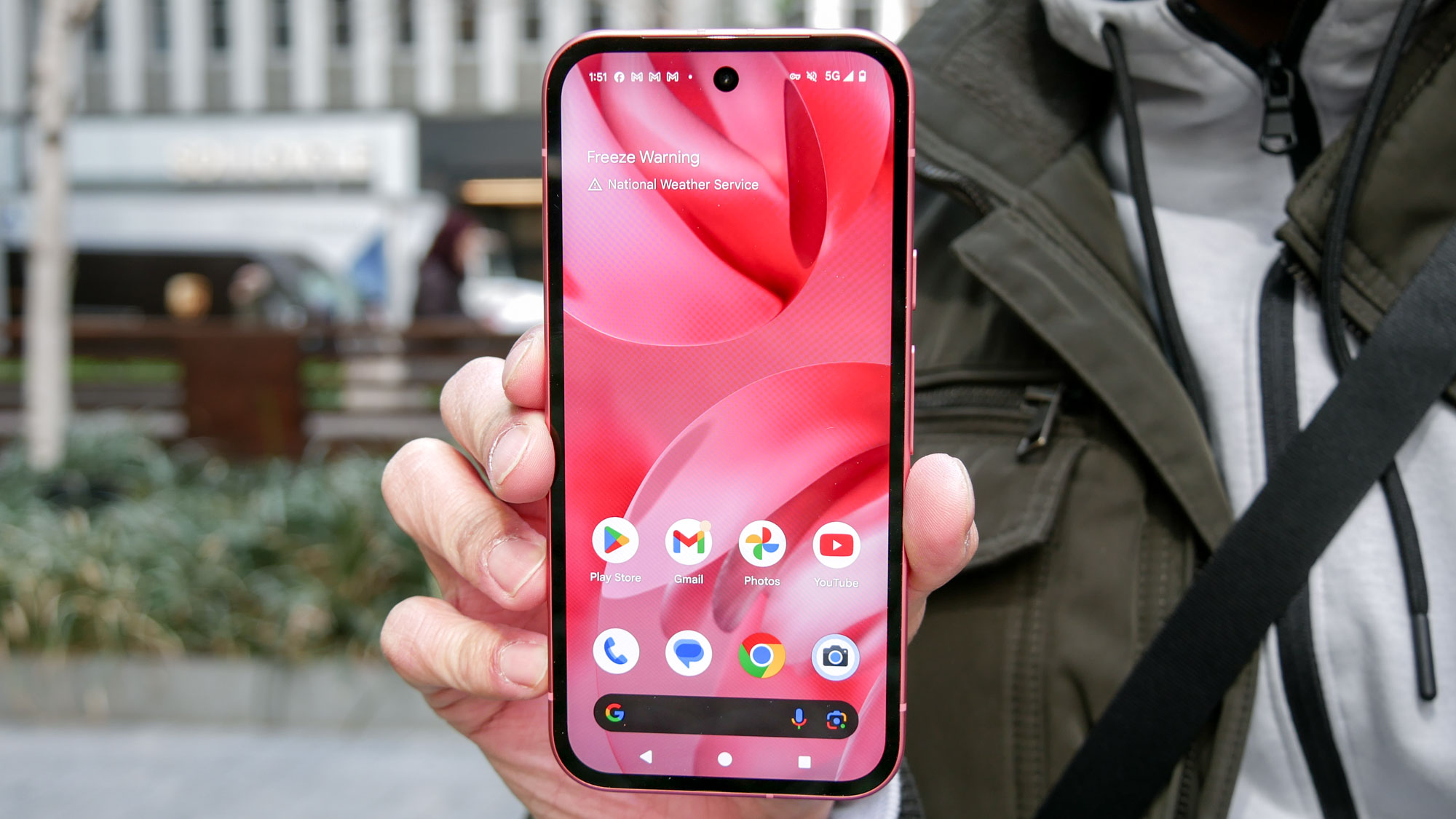 Google Pixel 9a held in the hand.